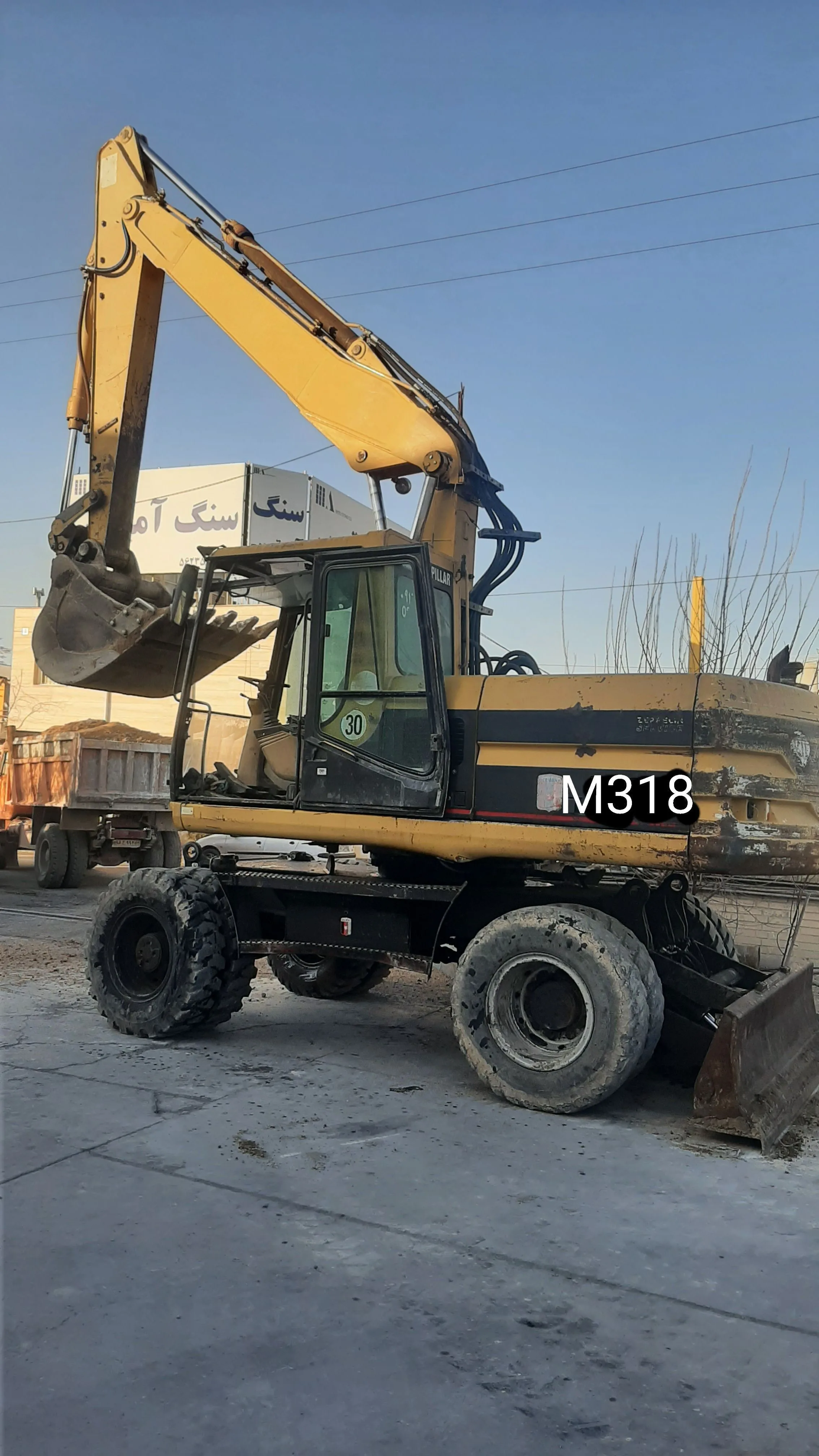 فروش بیل مکانیکی کاترپیلار لاستیکی M318